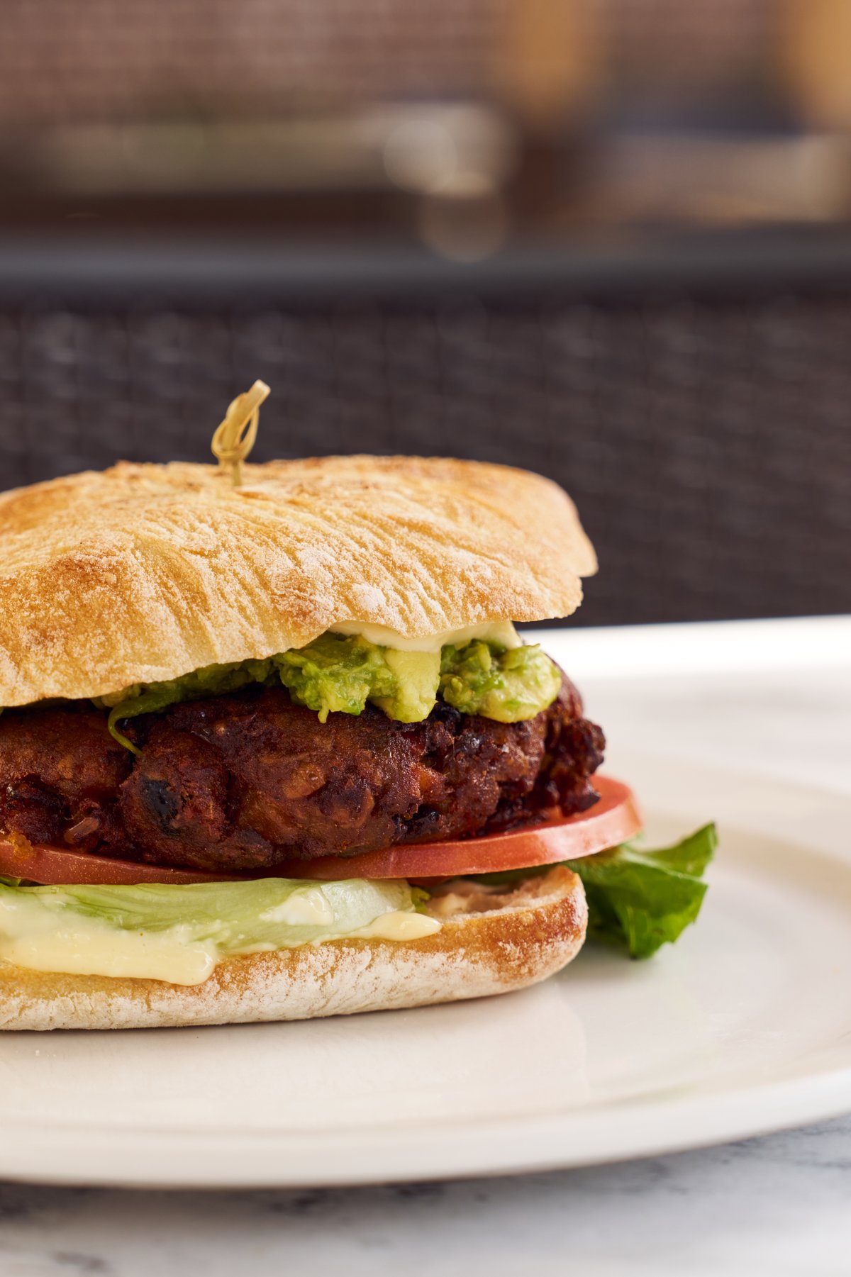 A hearty stacked sandwich with house sides